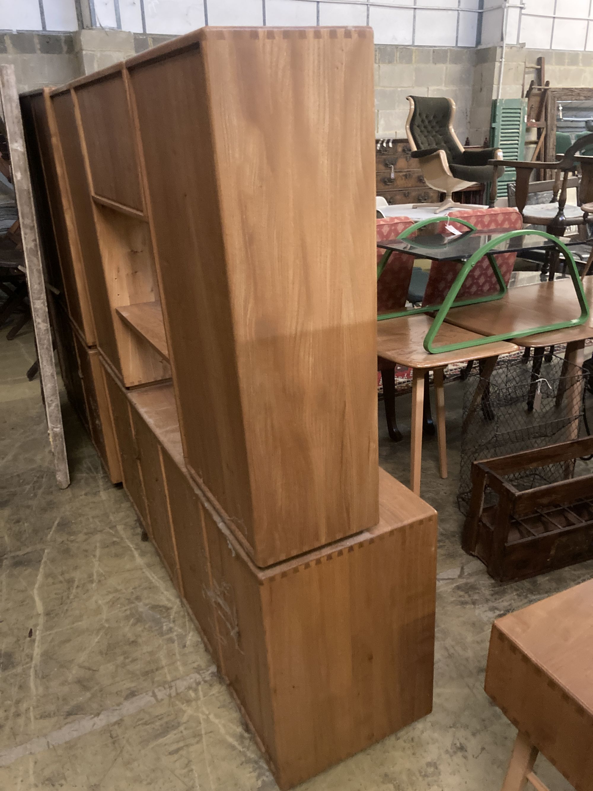 An Ercol elm glazed bookcase, width 155cm depth 44cm height 162cm